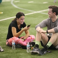 man and woman sitting on turf